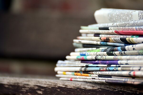 Photograph of a pile of newspapers