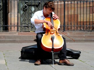 Photograph of a talented musician playing the cello in the center of Strasbourg